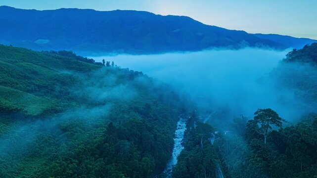 Aerial view of Sapan Village wrapped in soft morning fog, highlighting a popular highland travel destination known for fresh air, flowing streams, and unspoiled nature.
