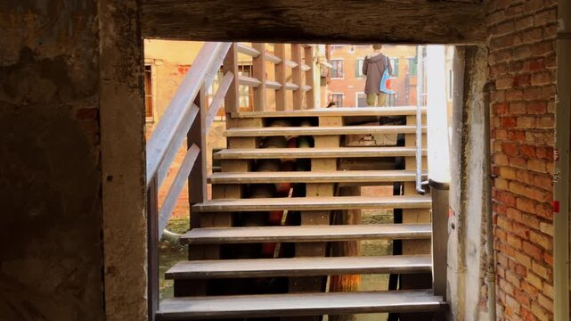 Walking up old wooden stairs to bright European street