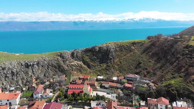 Village of Lin on the Rocky Peninsula Edge Along the Beautiful Shoreline of Lake Ohrid surrounded by emerald calm waters