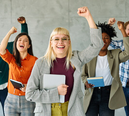 Portrait of a group of young happy business people having fun and celebrating during a meeting in...