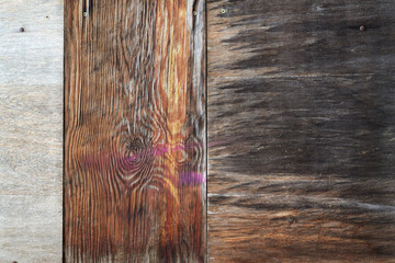 Close up of weathered wooden planks with pronounced grain, different brown tones and slight color traces. © EKH-Pictures