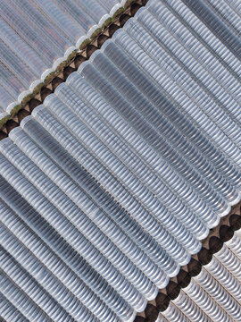Aerial view of a corrugated metal surface with repetitive patterns, reflecting light and shadow, creating a textured abstract, Stafford, England, United Kingdom.