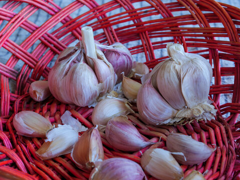 Top view of garlic in red wicker basket