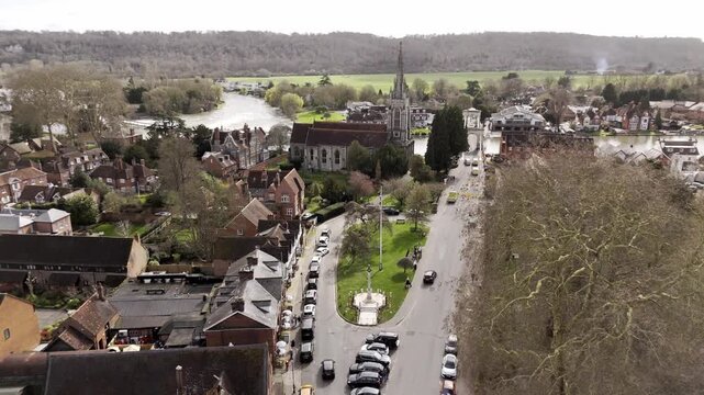 Drone fly past church steeple over River Thames in Marlow Buckinghamshire England