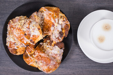 Traditional croissants with poppy seed filling and cup of coffee with milk. Dessert from polish city Poznan. Martin's croissant