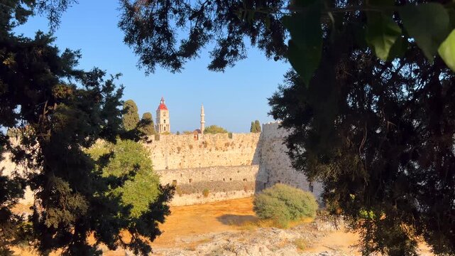 View of the Saint Nicholas Fort through the trees in Rhodes city, Greece