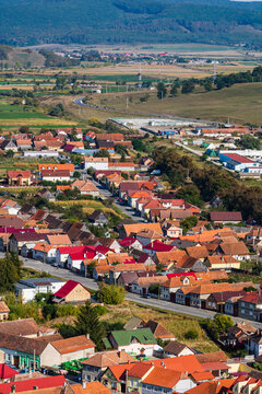 Aerial view of the town center with hills, buildings, streets, vegetation and surroundings in Rupea, Romania, 2021