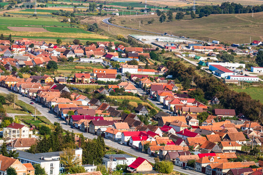 Aerial view of the town center with hills, buildings, streets, vegetation and surroundings in Rupea, Romania, 2021