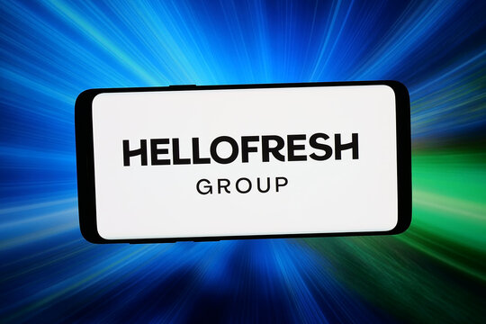 Stuttgart, Germany - 03-19-2026: In this photo illustration, the logo of German meal-kit company HelloFresh Group is displayed on a smartphone in front of abstract background on computer screen.