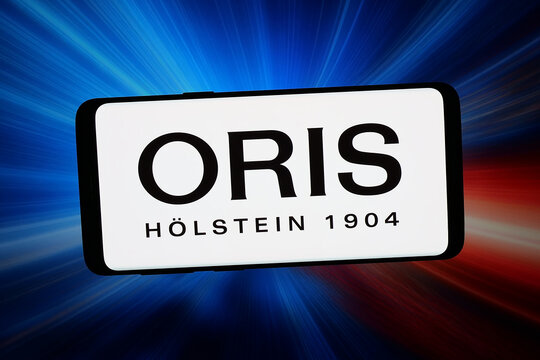 Stuttgart, Germany - 03-19-2026: In this photo illustration, the logo of Swiss watch manufacturing company Oris SA is displayed on a smartphone in front of abstract background on computer screen.