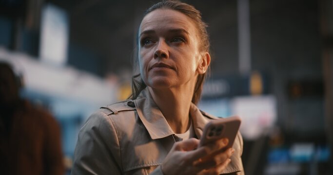 Focused Female Professional Reviews Boarding Pass, Holding Smartphone, Ensuring All Flight Details Correct Before Departure. Business Travel, Logistics, Airline Passenger Rights, Digital Connectivity.