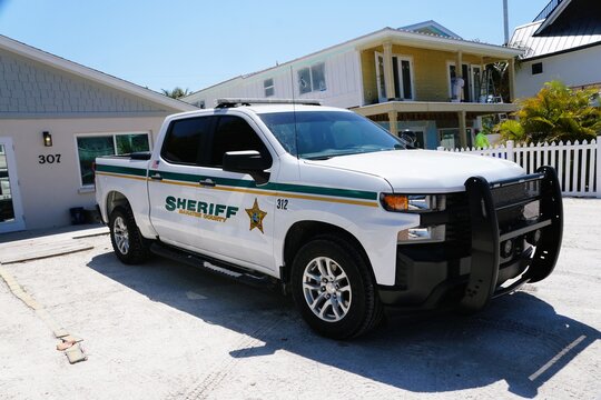 Anna Maria Island, Florida, U.S.A - March 26, 2026 - Manatee County Sheriff pickup truck parked near residential buildings