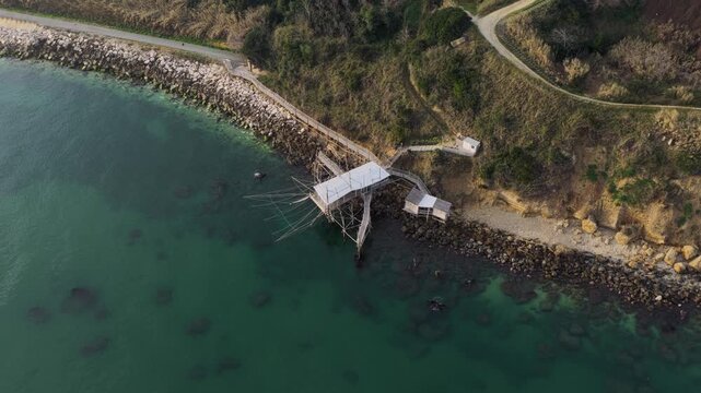 Aerial view of the Trabucco, a historic fishing construction, contrasts beautifully with the turquoise sea, San Vito Chietino, Abruzzo, Italy.