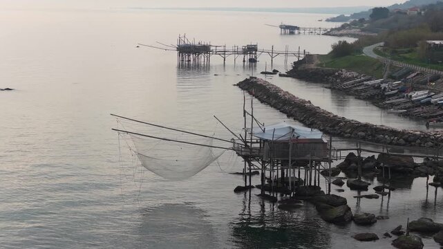 Aerial view of the traditional Trabocchi fishing platforms stand as rustic silhouettes against the tranquil Adriatic Sea, San Vito Chietino, Abruzzo, Italy.