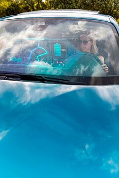 Confident driver checking battery level on smart vehicle display