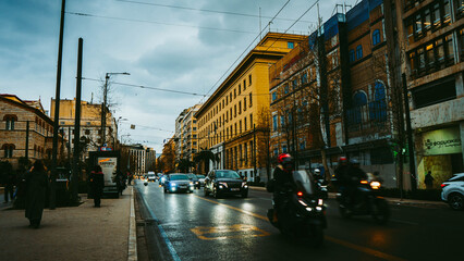 Busy Athens city street with traffic motorcycles and neoclassical buildings at dusk © Aaron