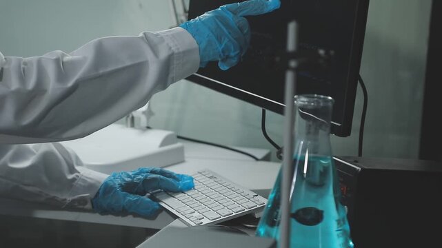 Medical or scientific researcher or man doctor looking at a test tube of clear solution in a laboratory