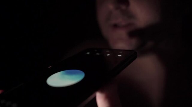 Man Talking to AI Voice Assistant at Home