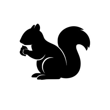A black silhouette of a squirrel holding a nut in its paws