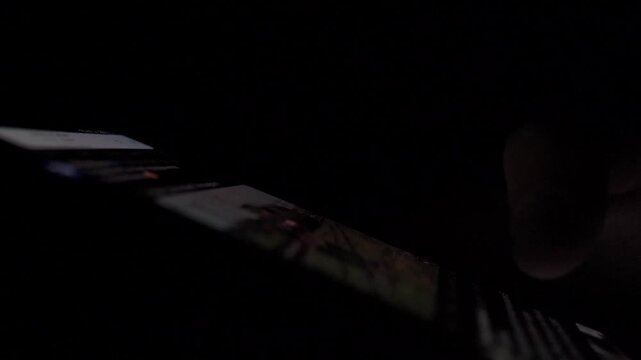 Man Reading Tweets and Night News on Smartphone