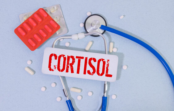 The inscription CORTISOL is written on a notebook.