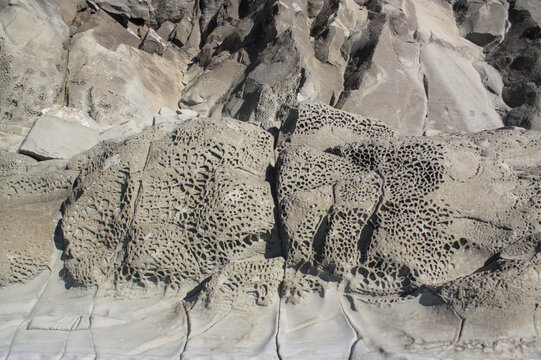 Close-up of eroded rock formations with natural textures and patterns in Ngapali, Rakhine State, Myanmar. Geological coastal detail shaped by erosion in tropical Southeast Asia.