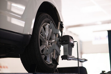 Car wheel alignment procedure in modern garage © TetianaRUD