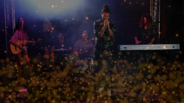 Golden particle overlay shifting, revealing band performing music in club while vocalist singing