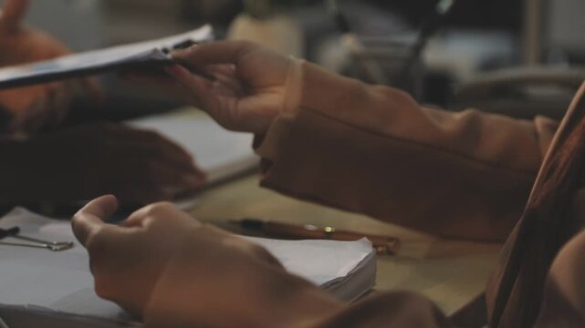 Close up of businessman or accountant hand holding pen working on calculator to calculate business data, accountancy document and laptop computer at office, business concept
