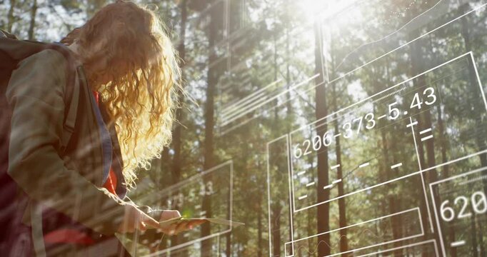 Woman tapping handheld device and populating AR schematics while collecting field data in forest