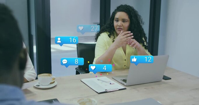 Speaking lead in yellow gesturing, remarks sparking reactions in office to prompt feedback, laptop