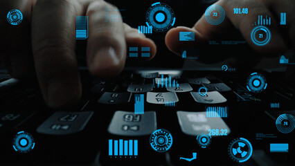 Close-up view of hands on a keyboard interacting with a futuristic digital interface featuring...