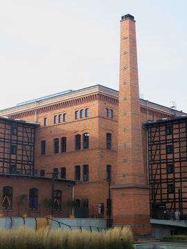 Restored red-brick industrial building with chimney