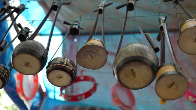 Traditional Bengali Ektara displayed for sale in a street shop, reflecting rich heritage, folk music culture, and local craftsmanship, perfect for themes of tradition and identity. Musical Instrument