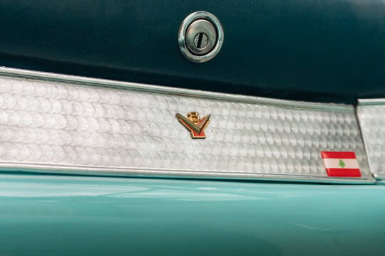 Turquoise Ford Thunderbird glovebox lock and V8 emblem detail, Classic vintage car interior details