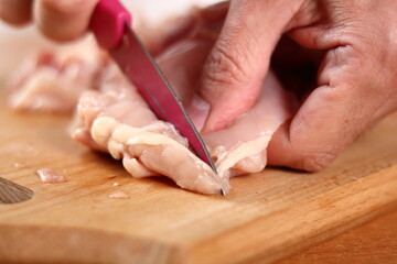 Obraz premium Cutting Chicken Drumstick Fillet