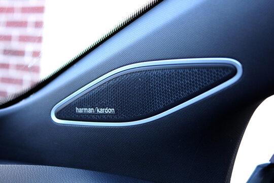 Vinnytsia, Ukraine; March 28, 2026. Volkswagen ID.4 Pro speaker by Harman Kardon audio system. Close-up of black textured dashboard speaker in Volkswagen ID.4. Oval Harman Kardon grille with silver me