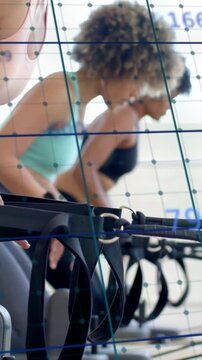 Vertical video: Women syncing Pilates reformer hinging as numeric grid counting reps for timing