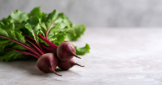 Fresh beets with green leaves on surface