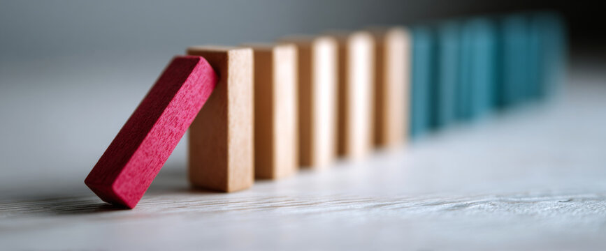 Red domino toppling wooden blocks sequence