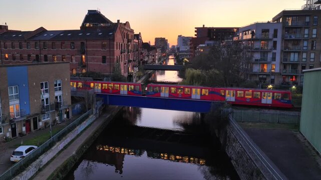 DLR Train Crossing Limehouse Cut Bridge at Sunset 4K Video