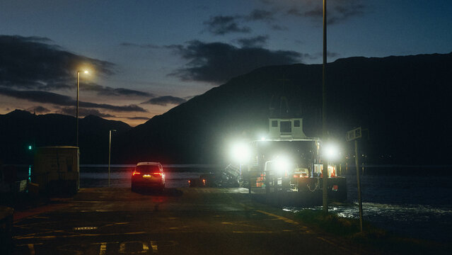ferry traffic at sunset in the lake and mountains