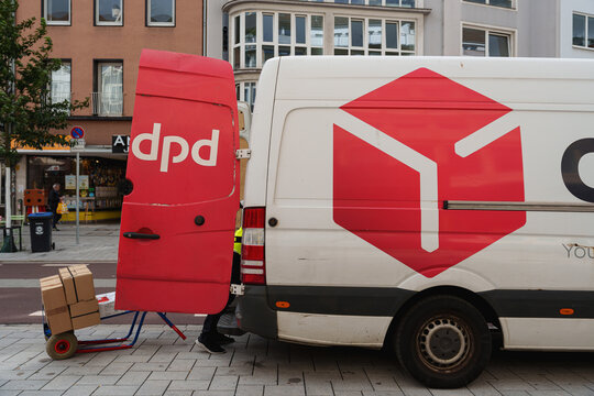 Dusseldorf, Germany - September 11 2025: DPD courier van parked while worker preparing parcels for delivery