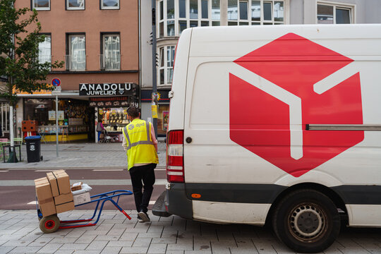 Dusseldorf, Germany - September 11 2025: DPD courier van parked while worker preparing parcels for delivery