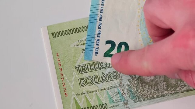 Comparing 20 Euro Banknote and 10 Trillion Zimbabwe Dollars. Currency Value Contrast Concept 4K