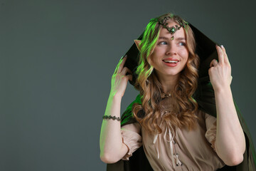 Obraz premium Beautiful girl dressed as elf on grey background, space for text