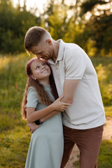 Obraz premium Father Kissing Daughter Forehead In Meadow, Tender Gesture And Warm Light, Protective Paternal Affection With Intimate Eye Contact, Summer Attire And Peaceful Outdoor Mood