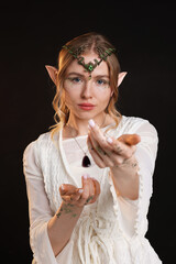 Obraz premium Beautiful girl dressed as elf on dark background