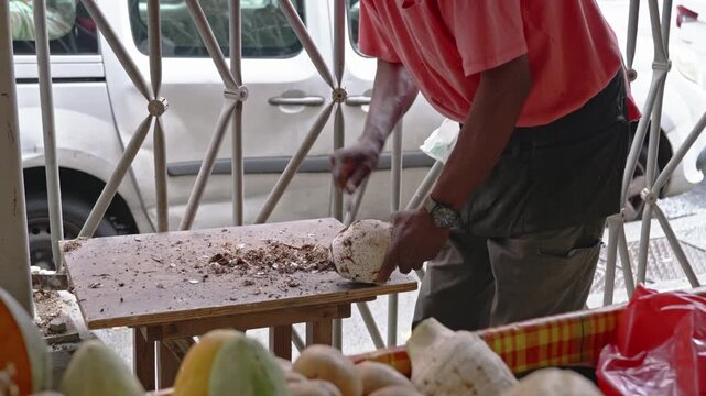 Martinique Market Vendor Preparing Fresh Root Vegetable: Authentic Caribbean Ground Provision and Local Produce Preparation