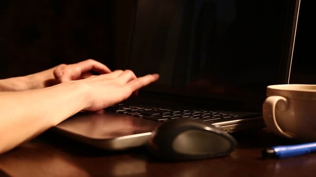 Business woman typing on keyboard the fingers, drinking coffee. Laptop placed on the wooden desk near coffee cup and computer wireless mouse. Closeup series of videos from different angles